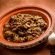 open tajine with meat, onion, dried grape and cinnamon
